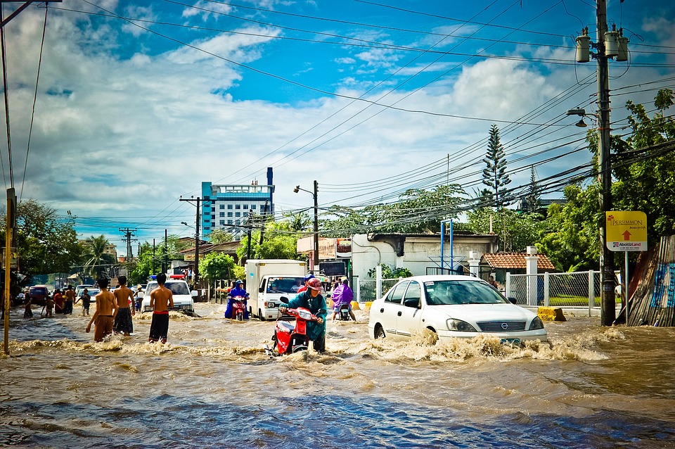 people travelling along a flooded city street